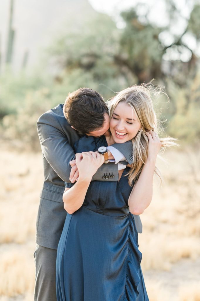 Salt River engagement session with couple laughing and embracing