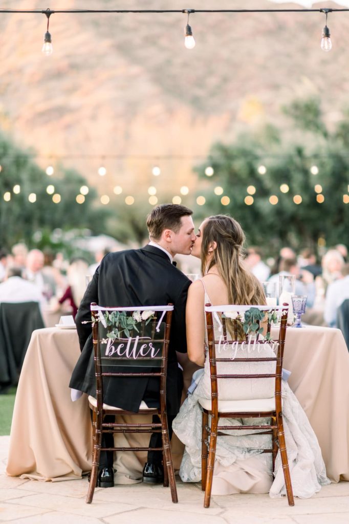 Couple sitting at table during reception at El Chorro Paradise Valley