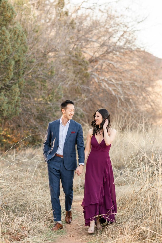 Couple walking in tall grass Sedona engagement session