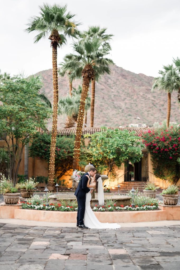 Bride and groom in the entryway of the Royal Palms resort a luxury wedding venues in Scottsdale with a mountain view