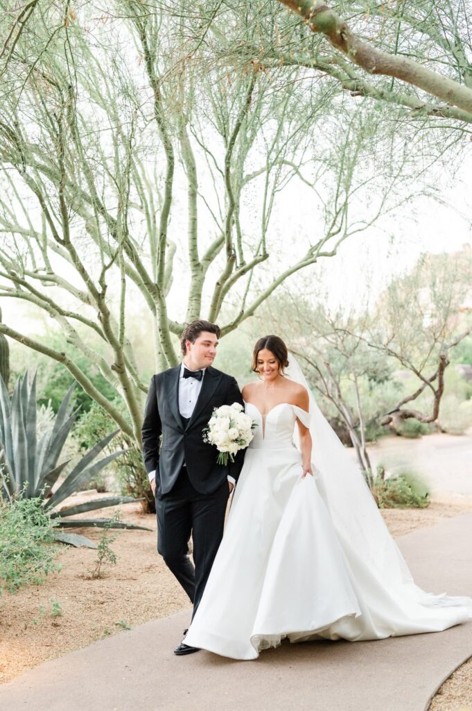 Bride and Groom walking down the path at the Four Seasons Scottsdale