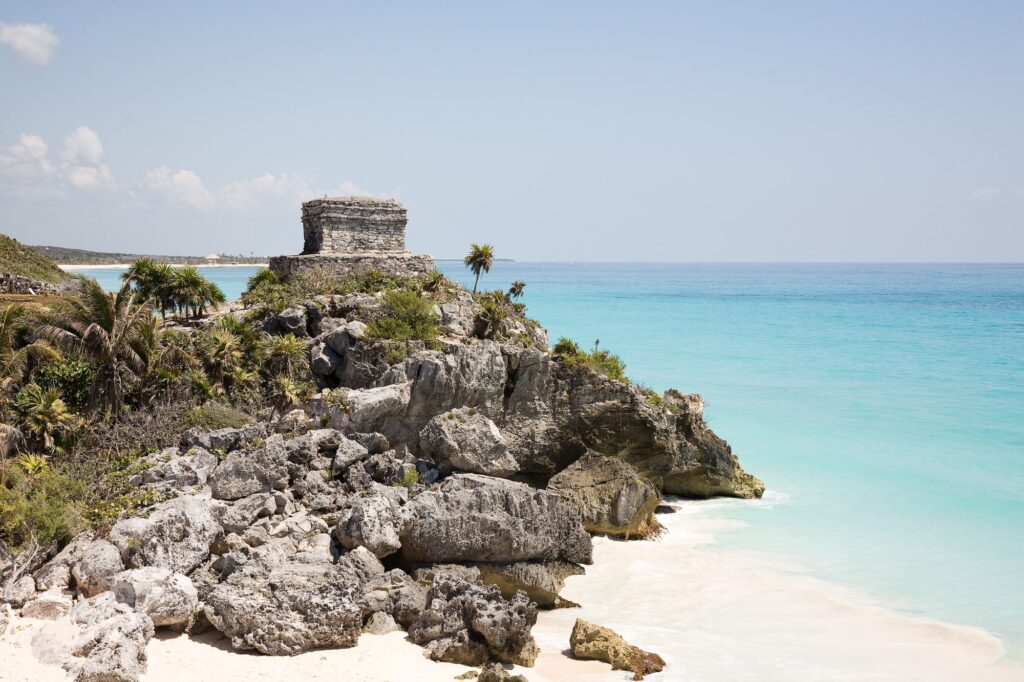 Tulum ruins on the cliffs and beach overlooking the ocean in Tulum Mexico.