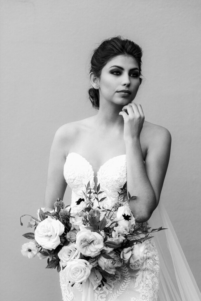 Bride holding her bouquet in a more fashion editorial pose.